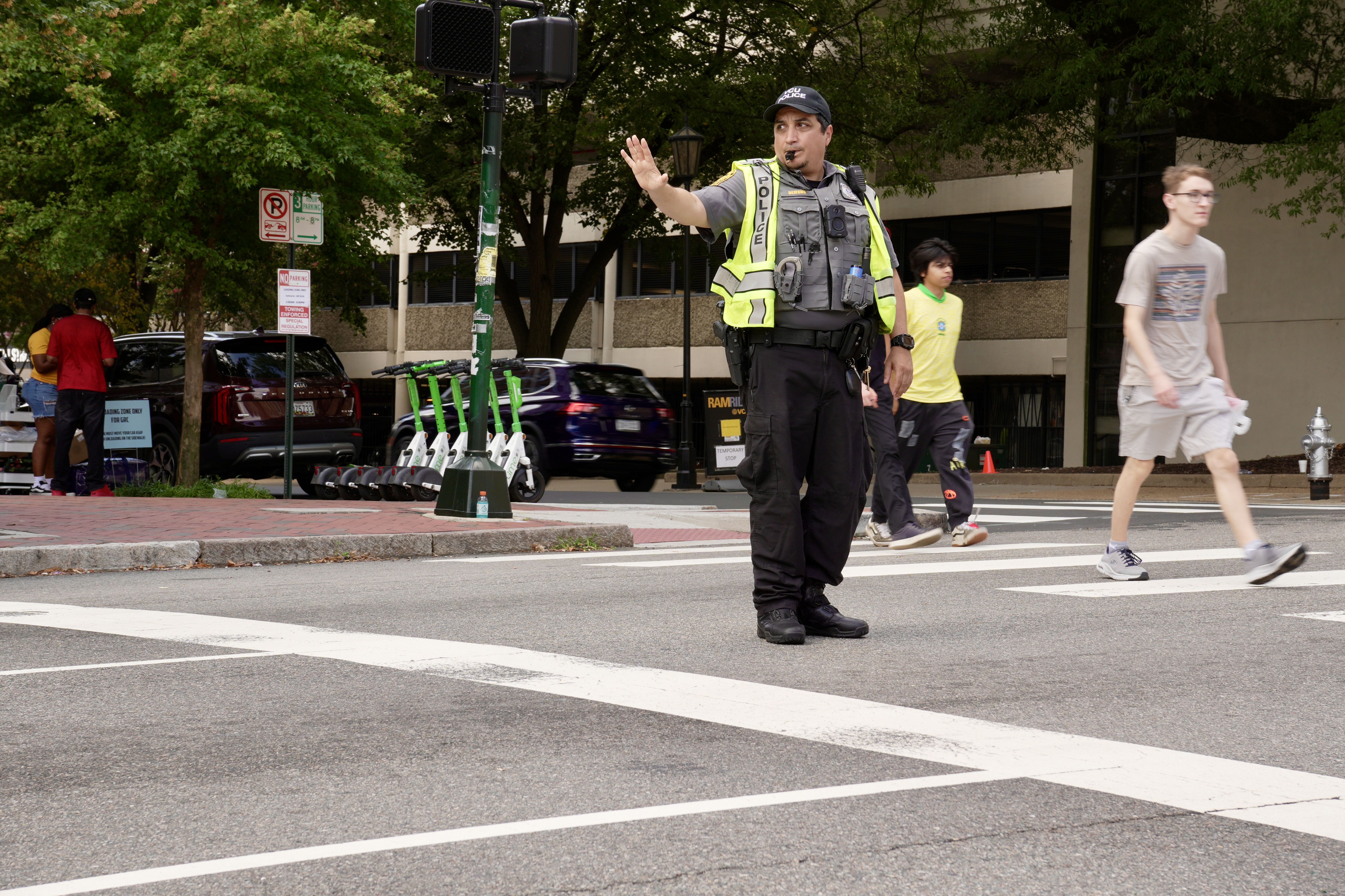 A VCU Police officer directs traffic on W. Main Street near Gladding Residence Center during VCU Move-in Day.