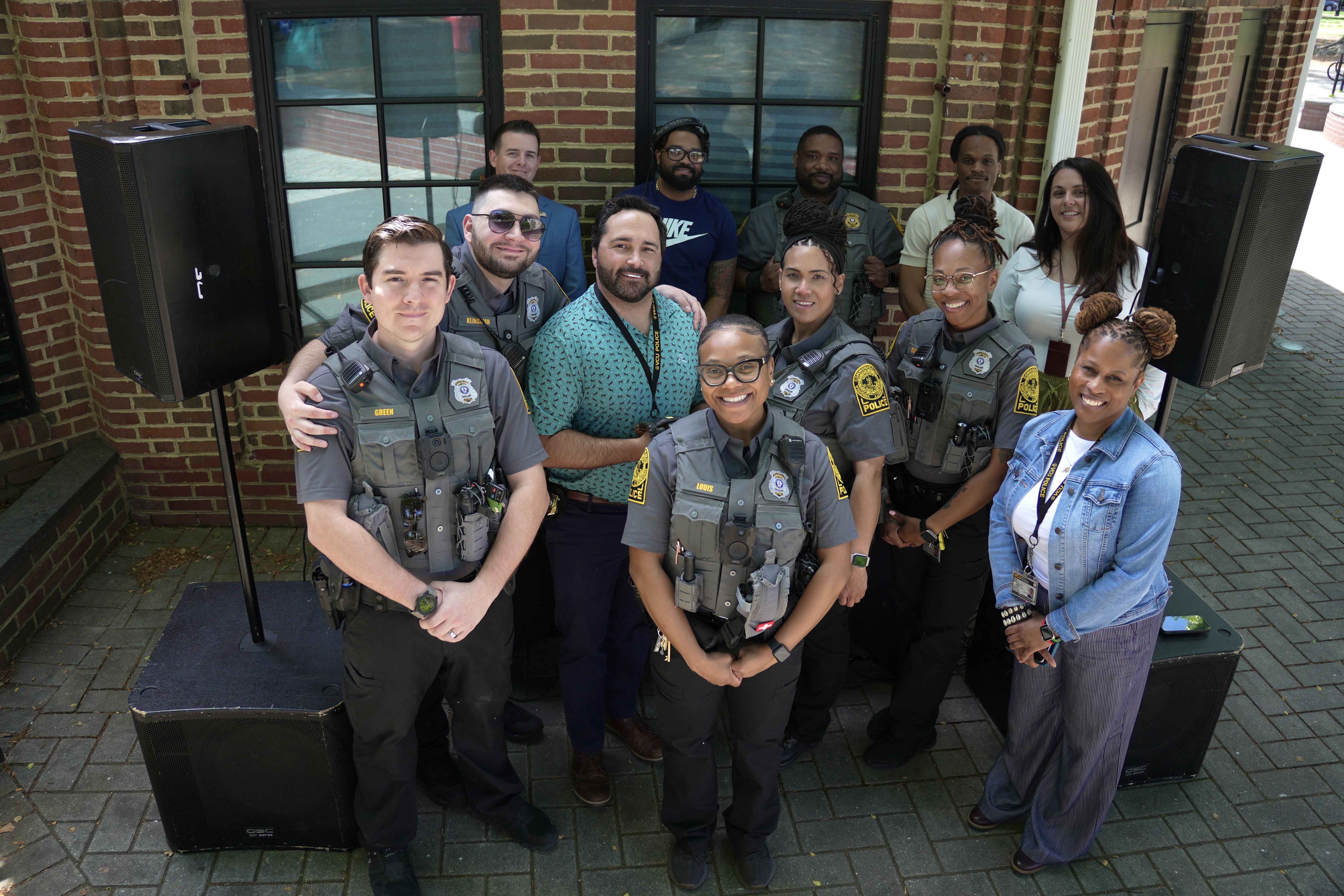 Twelve VCU Police officers smile for a photo at an event in Monroe Park.
