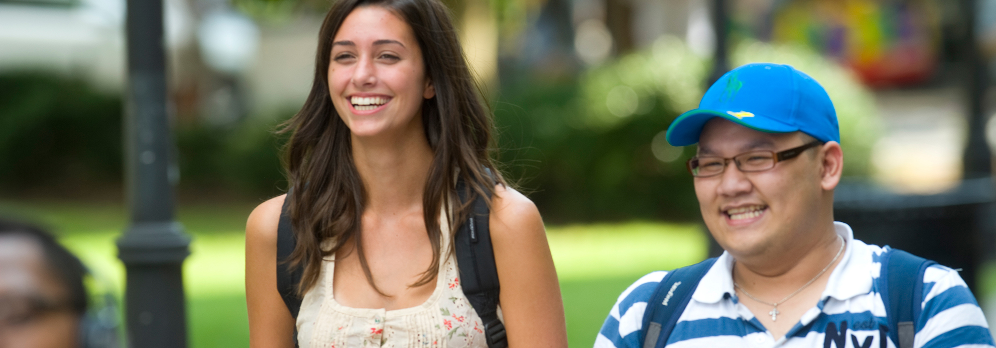 Two smiling students walking to class