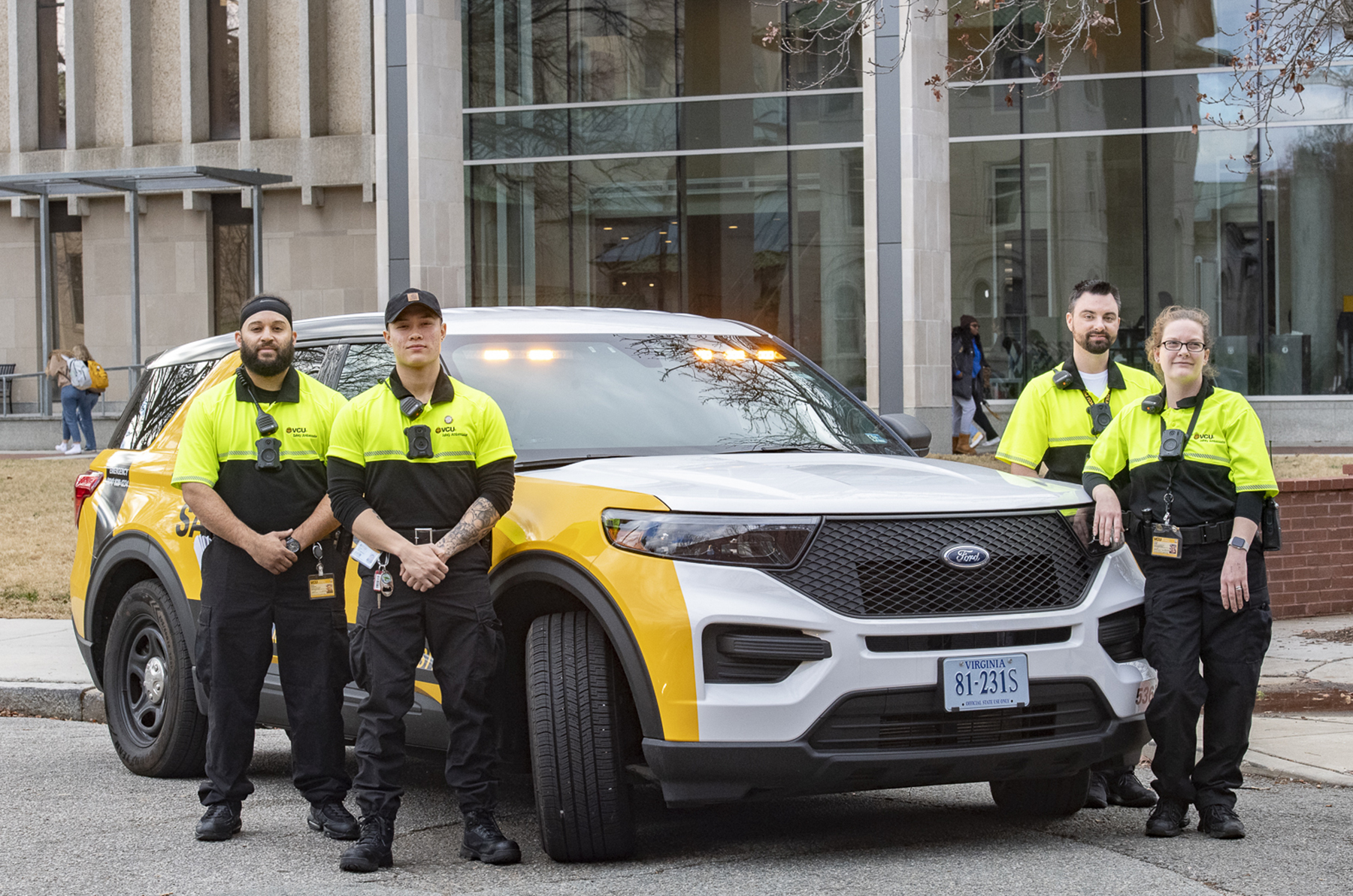Picture of Safety Ambassadors standing next to a VCU Police vehicle.
